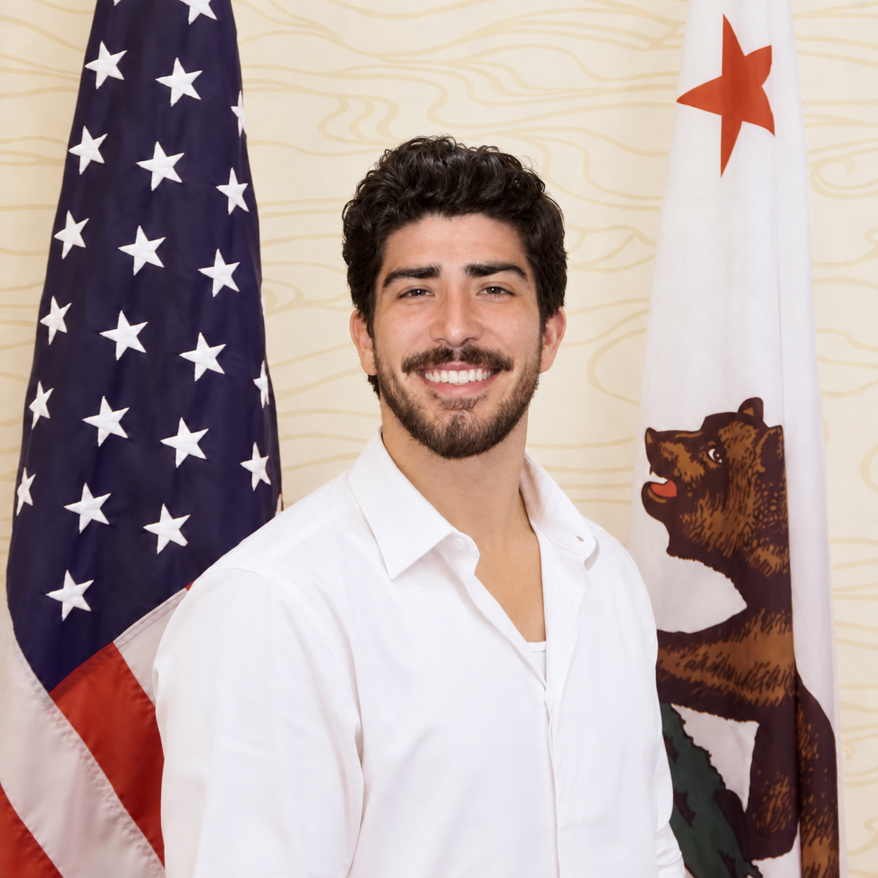 Tim Yslava standing between the United States and California flags